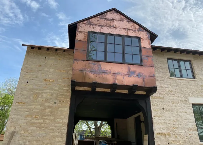 Copper metal panel facade on a stone building for Metal Roof Coating in Ammon